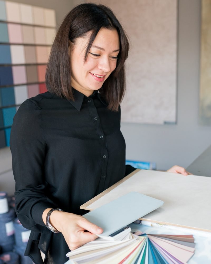 woman-choosing-materials-for-home-renovation-interior-designer-looking-at-color-samples-for-wall.jpg